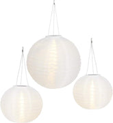 Three white spherical pendant lights hanging against a white background